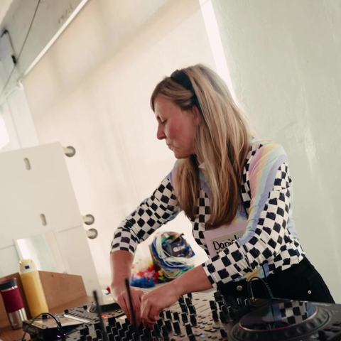 DJ Daniela mixing on Pioneer decks at Tiny Rave